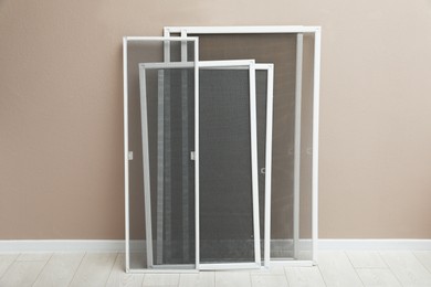 Photo of Set of window screens near beige wall indoors