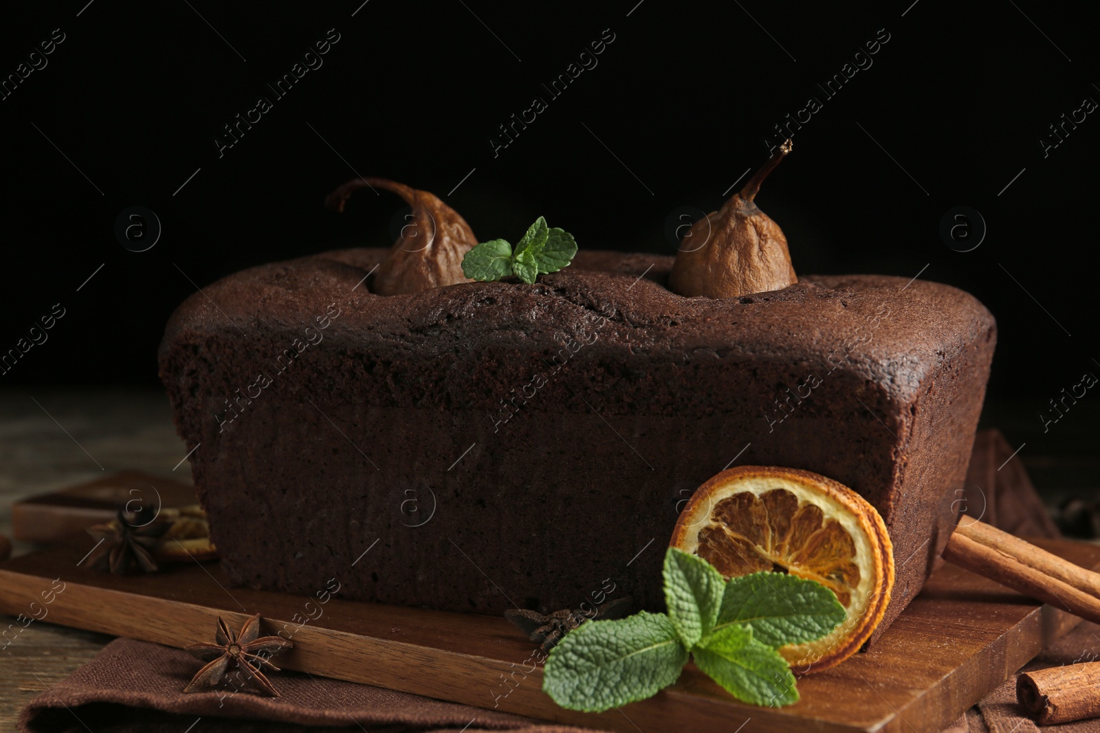 Photo of Tasty pear bread with mint and dried orange slice on table. Homemade cake