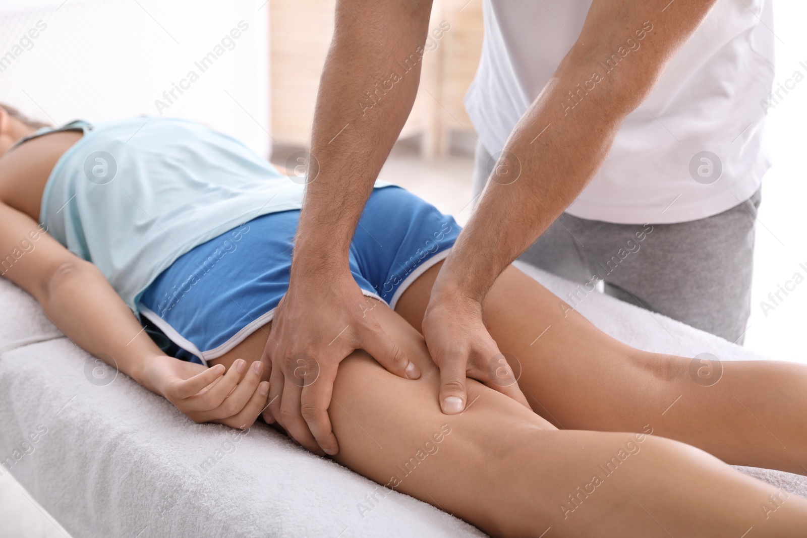 Photo of Young woman receiving massage in salon, closeup