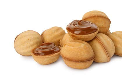 Photo of Delicious nut shaped cookies with boiled condensed milk on white background