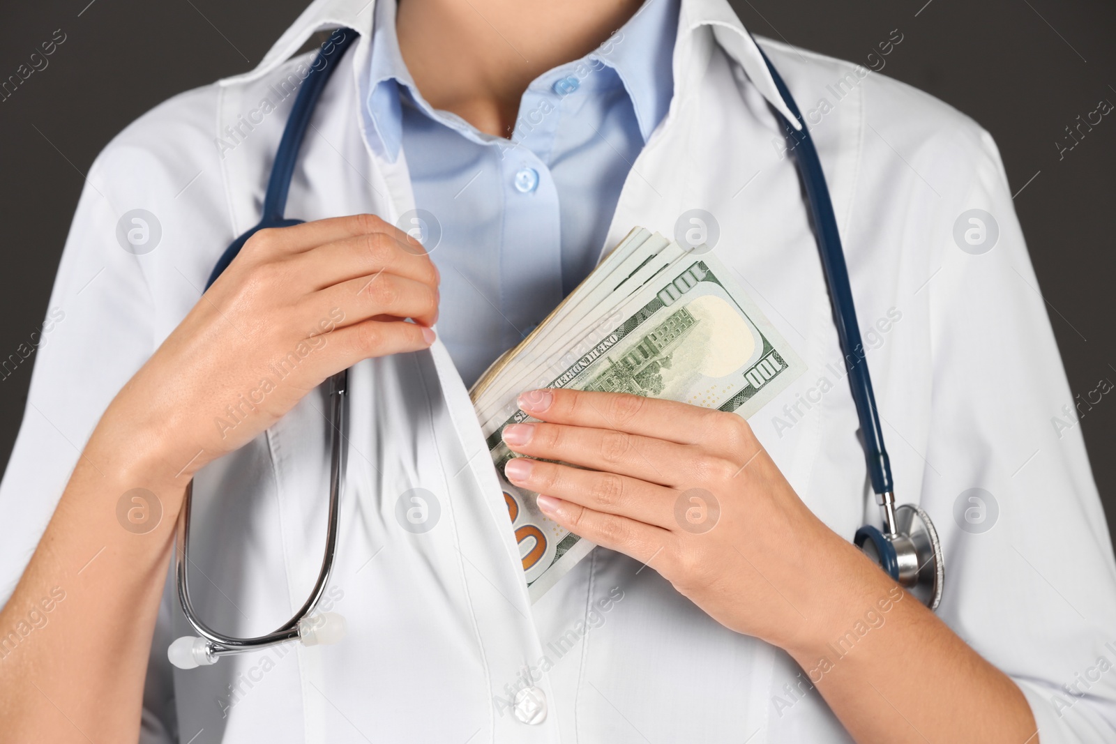 Photo of Doctor putting bribe into pocket on black background, closeup. Corruption in medicine