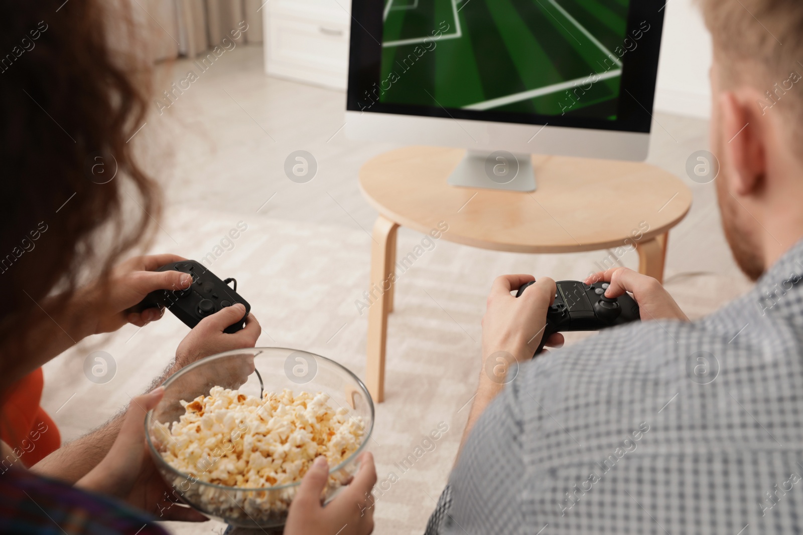 Photo of Young couple playing video games at home, closeup