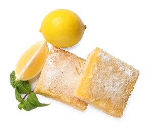 Photo of Tasty lemon bars with powdered sugar, fruits and mint isolated on white, top view