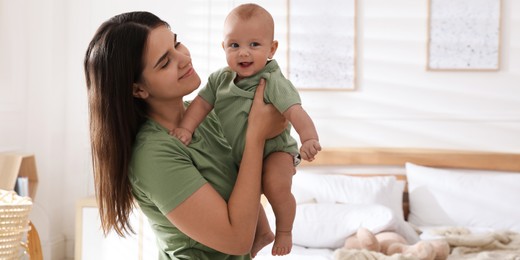 Mother with her cute baby at home. Banner design 