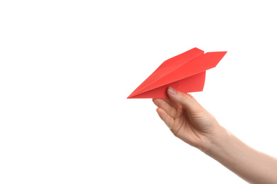 Photo of Woman holding red paper plane on white background, closeup