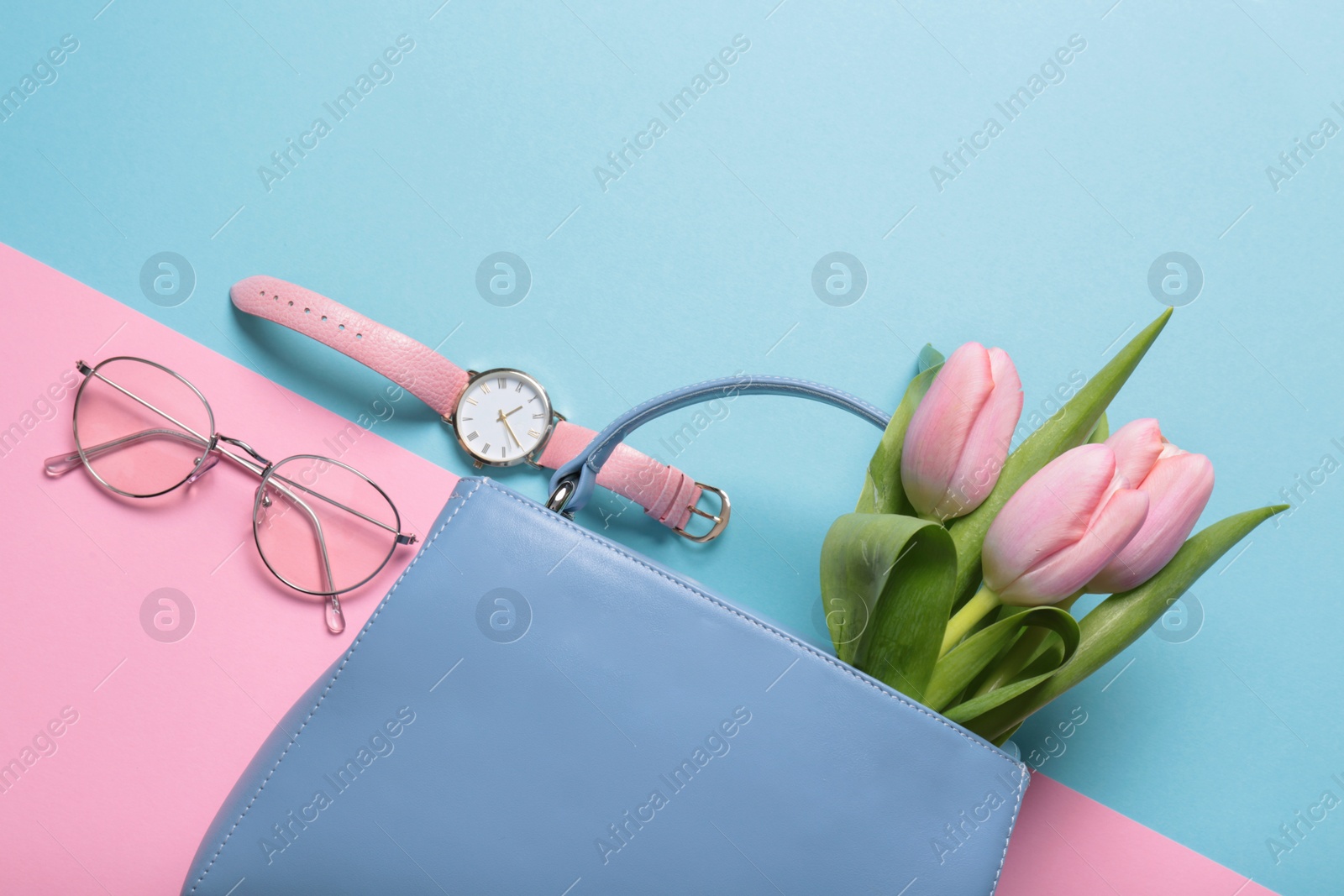 Photo of Flat lay composition with stylish woman's handbag and spring flowers on color background