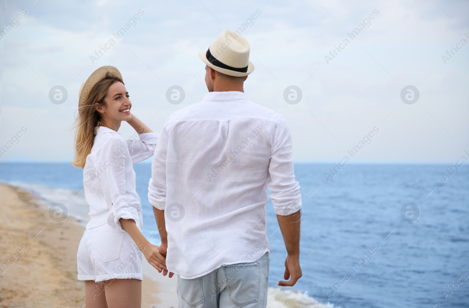 Photo of Happy couple having romantic walk on beach