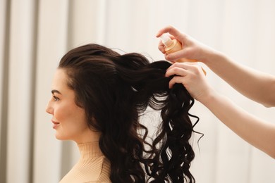 Photo of Hair styling. Professional hairdresser working with client indoors, closeup