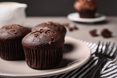 Delicious chocolate muffins served on table, closeup. Space for text
