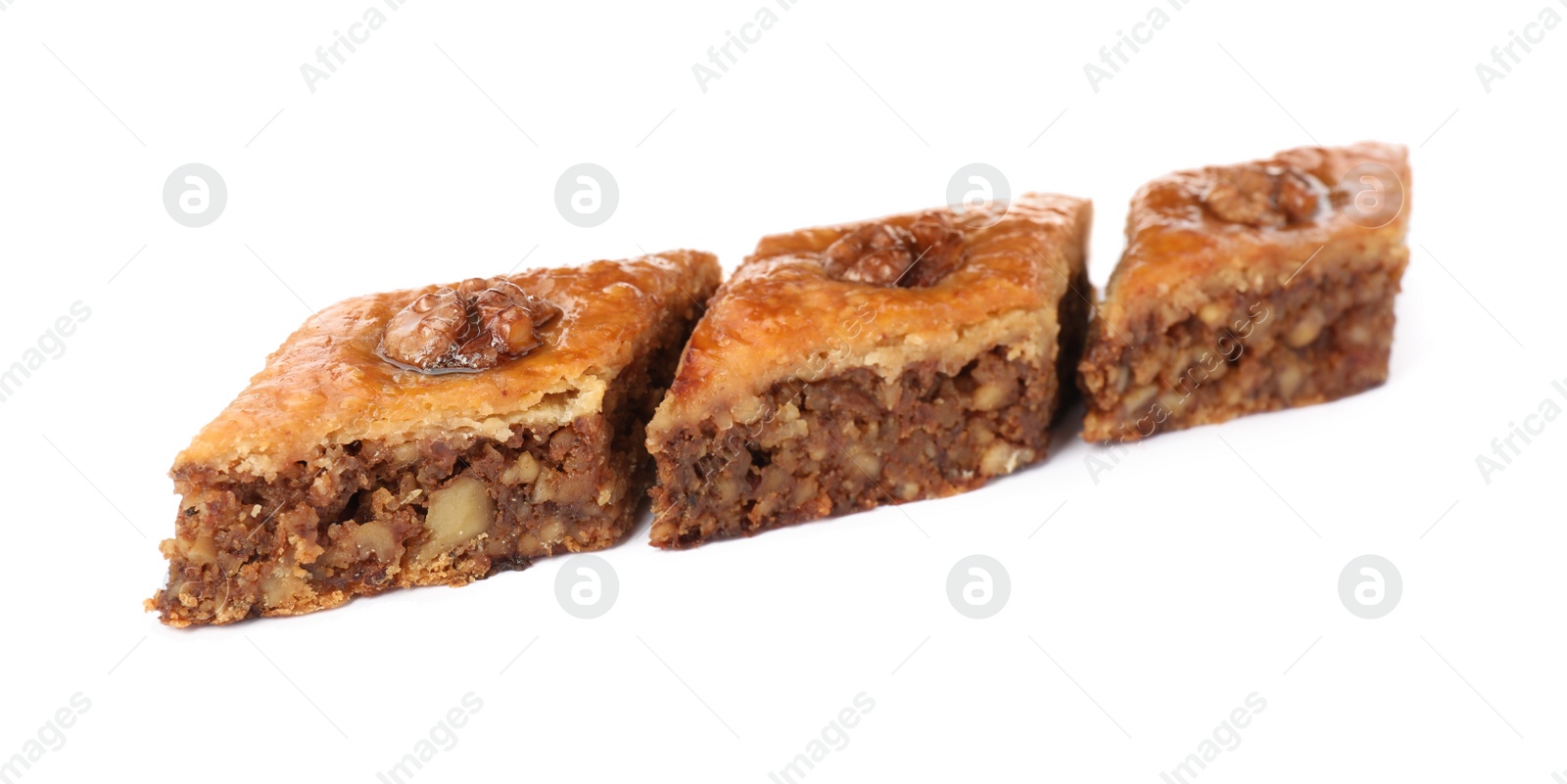 Photo of Delicious honey baklava with walnuts on white background