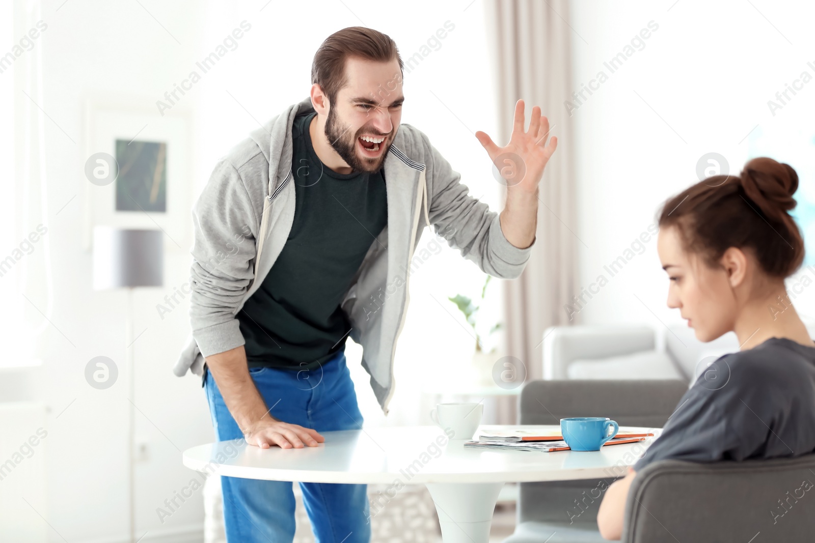 Photo of Young couple having argument at home