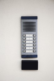 Modern intercom on beige wall. Security system