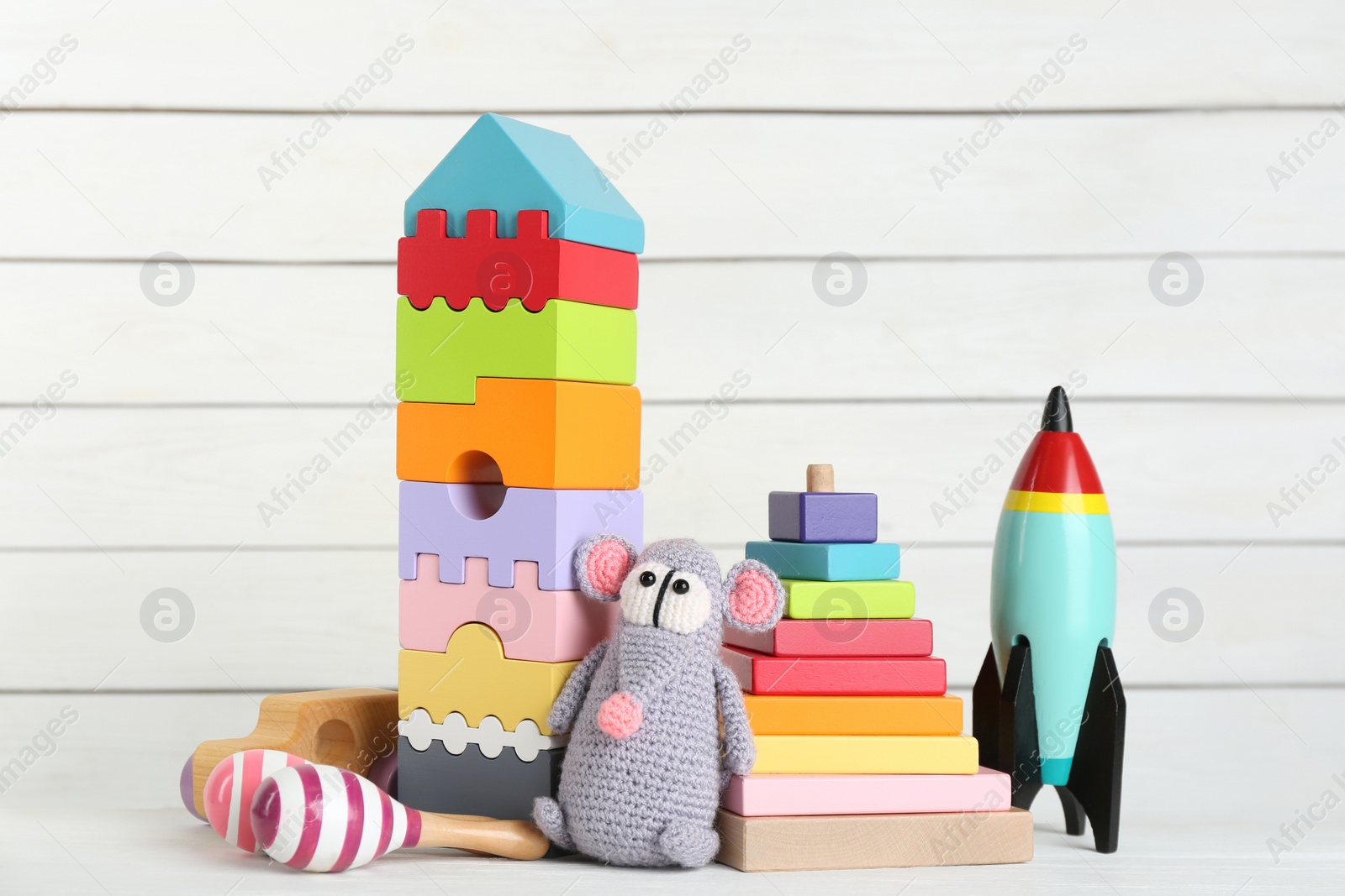 Photo of Set of different toys on white wooden table