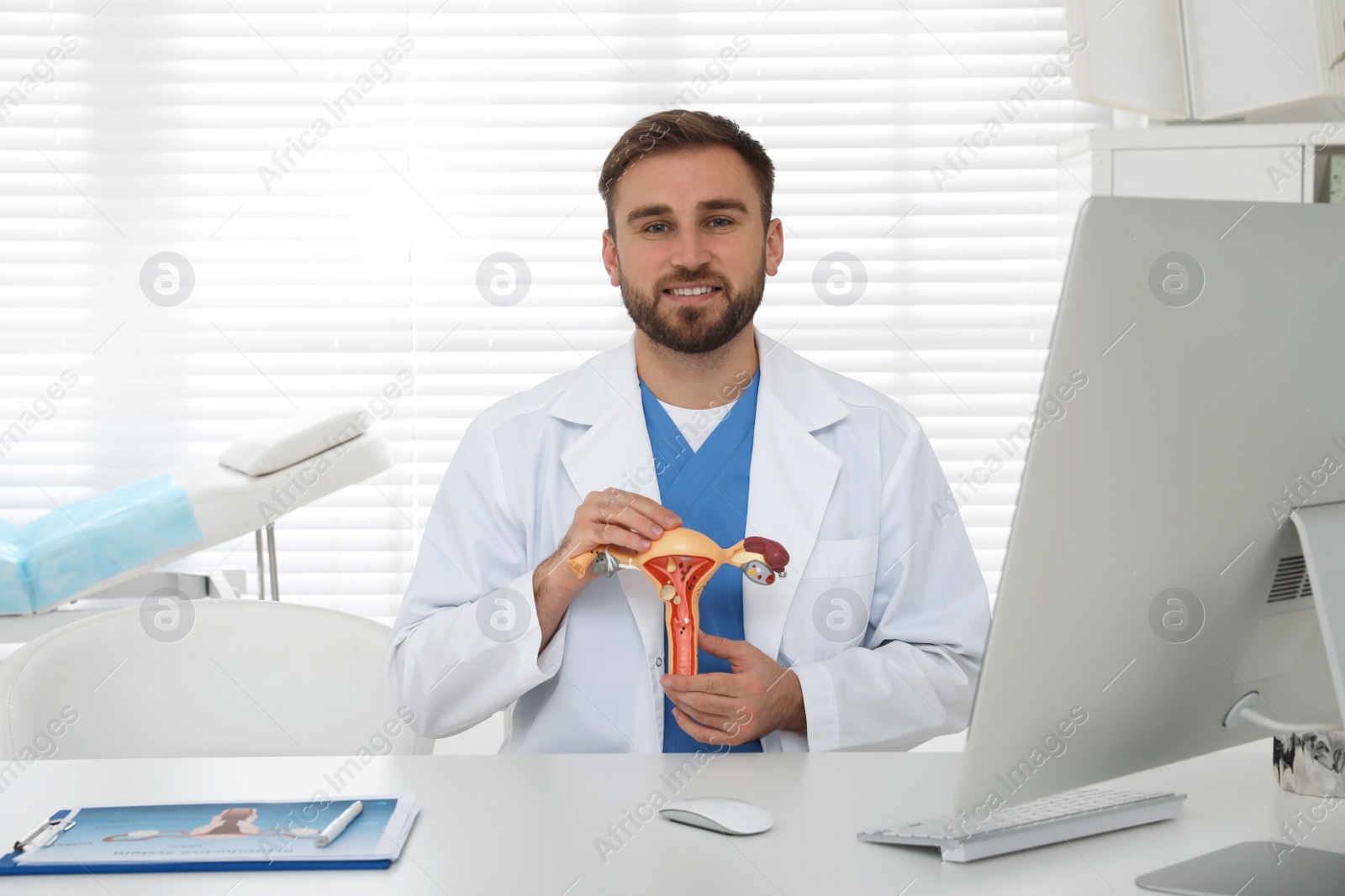 Photo of Gynecologist demonstrating model of female reproductive system in clinic