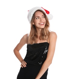 Happy young woman in Santa hat on white background. Christmas celebration