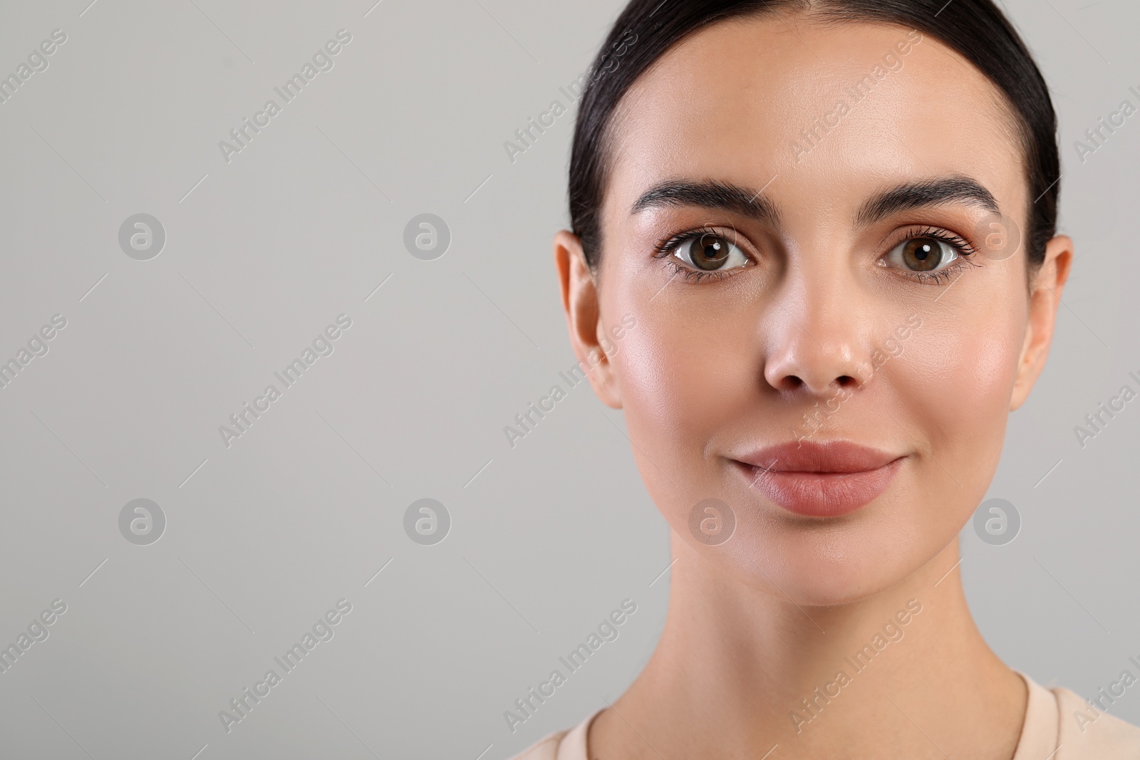 Photo of Portrait of beautiful young woman on grey background. Space for text