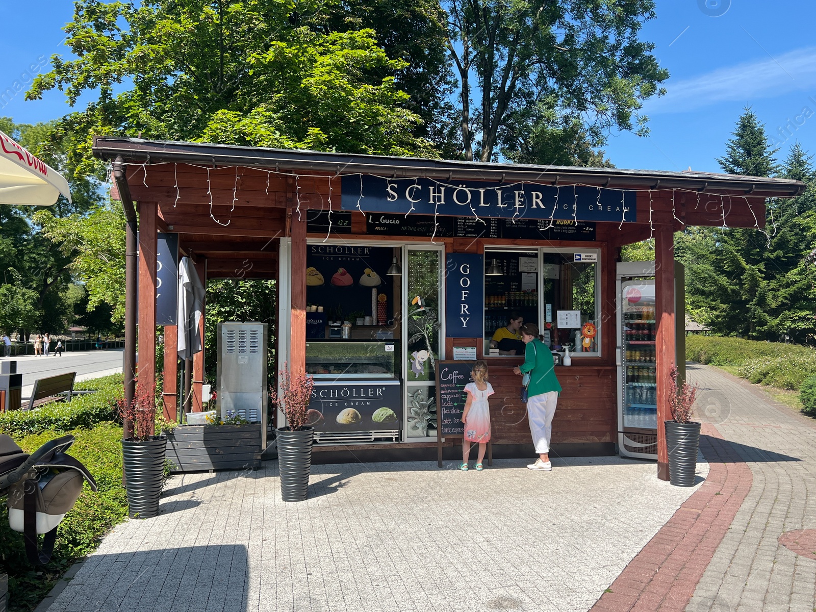 Photo of Stall with different products outdoors on sunny day