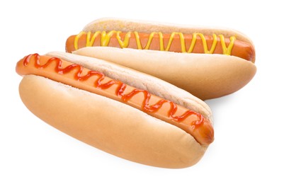 Photo of Tasty hot dogs with ketchup and mustard isolated on white