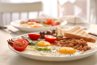 Tasty breakfast with fried eggs on light table, closeup