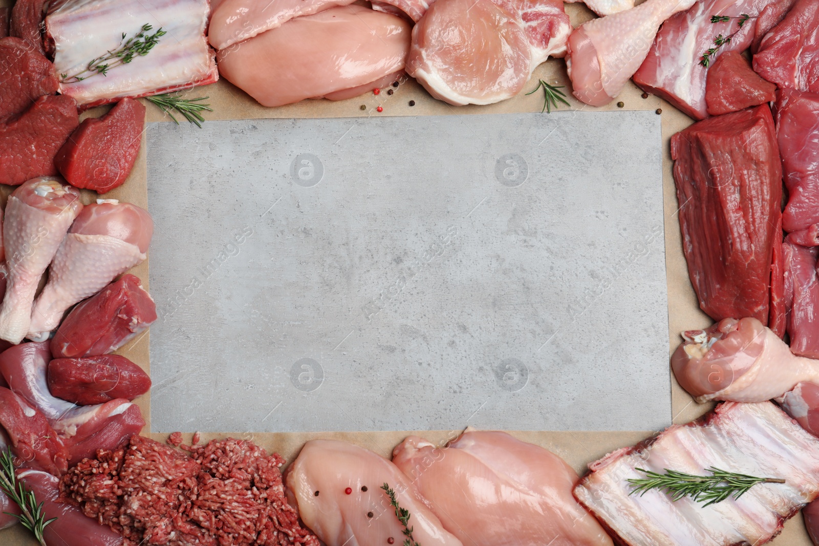 Photo of Flat lay composition with fresh raw meat and space for text on gray background