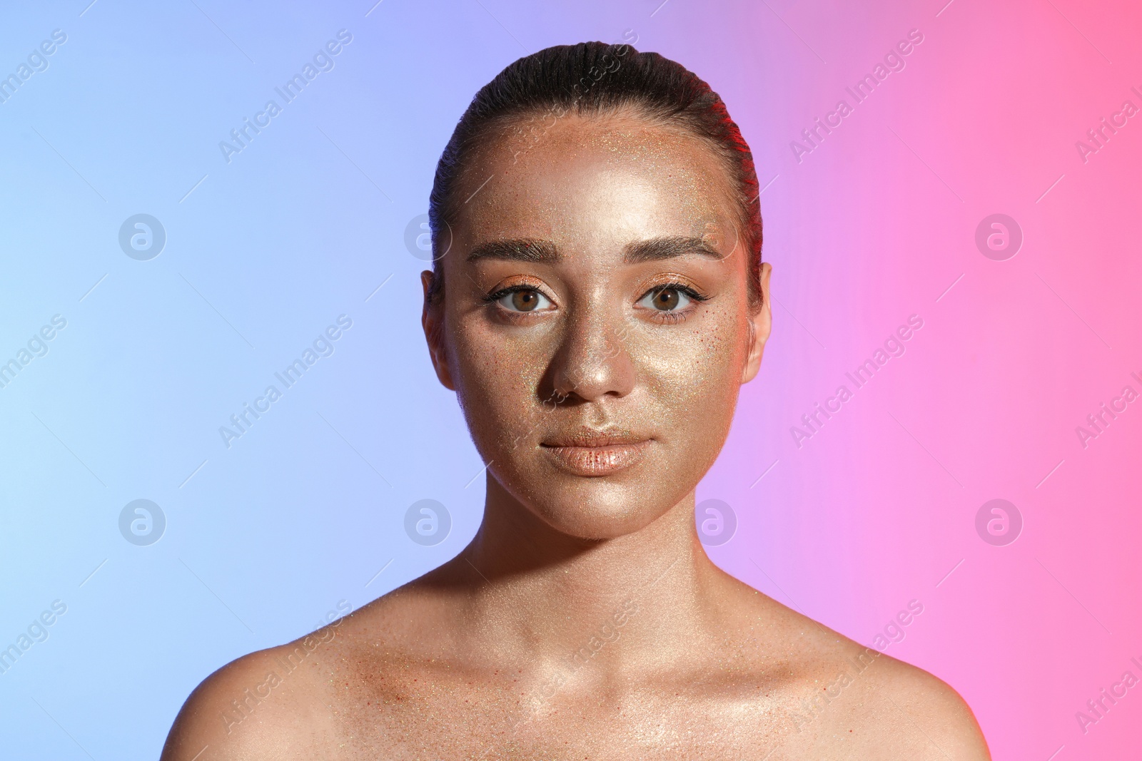 Photo of Beautiful young woman with glitter makeup on colorful background