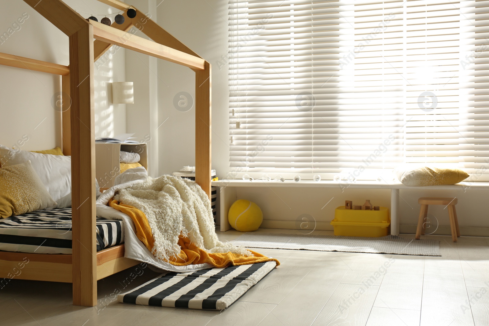 Photo of Cozy child room interior with comfortable bed