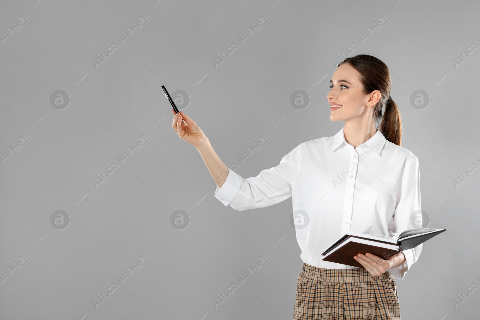 Photo of Portrait of young female teacher on grey background. Space for text