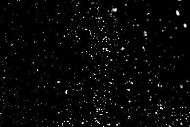 White snow falling down on black background