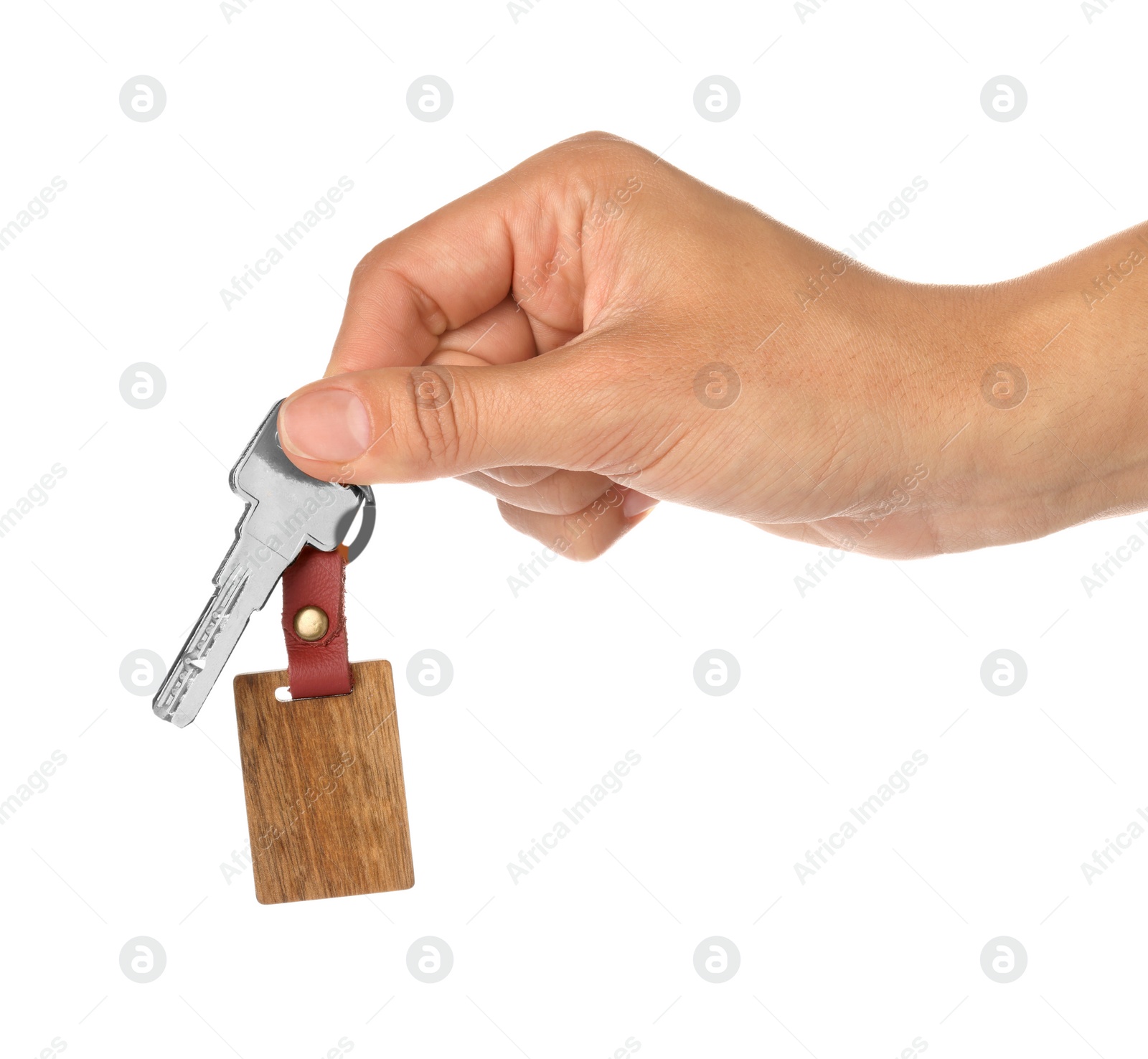 Photo of Woman holding key with wooden keychain on white background, closeup