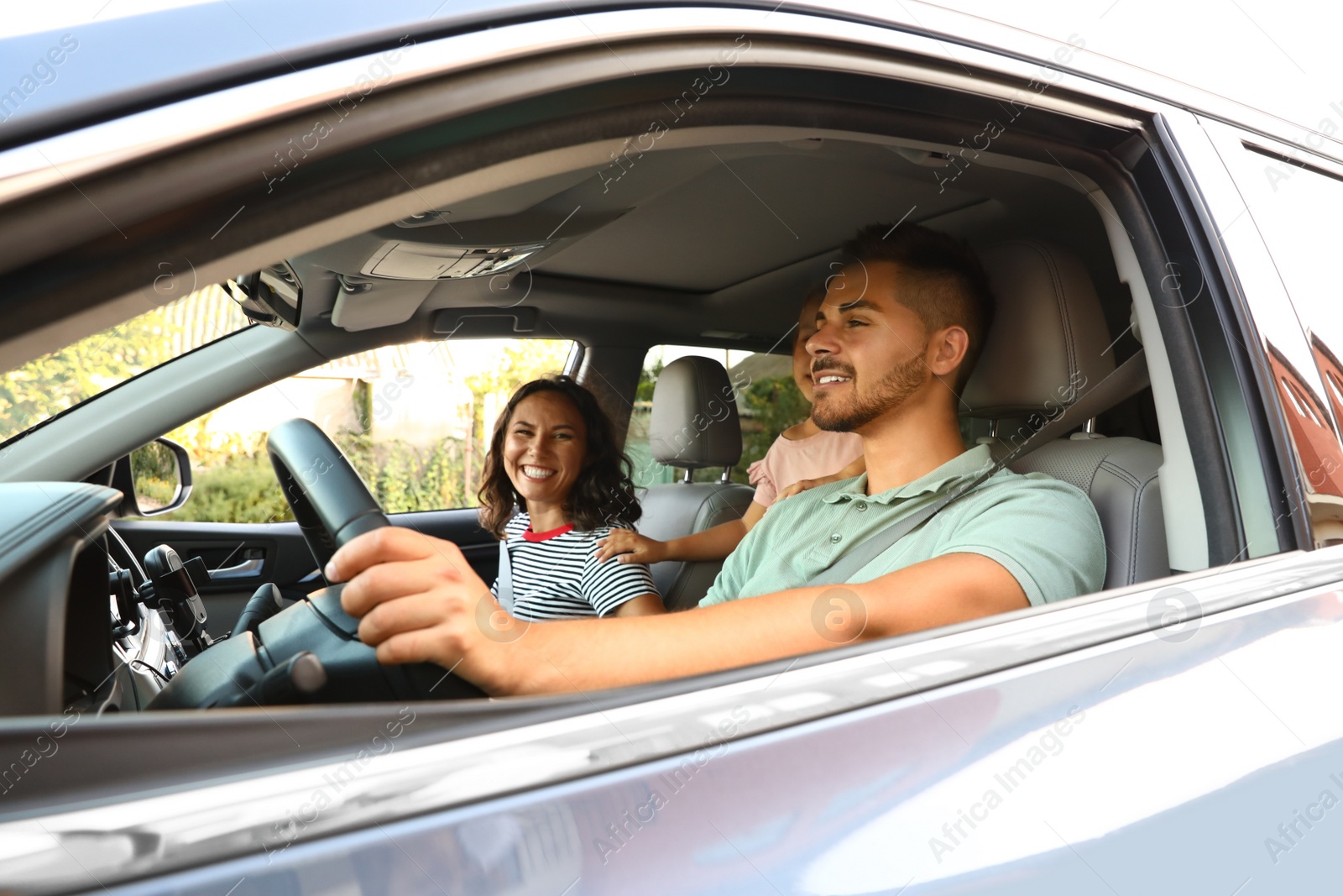 Photo of Happy family traveling by car on summer day