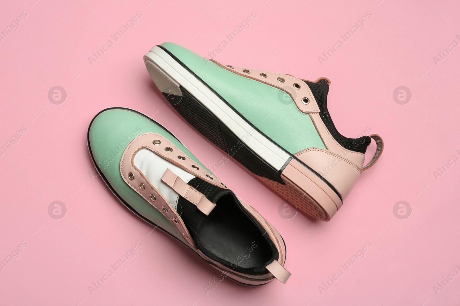 Photo of Flat lay composition of stylish shoes on color background