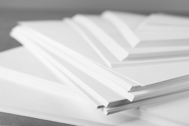 Photo of Stack of blank paper on grey table, closeup