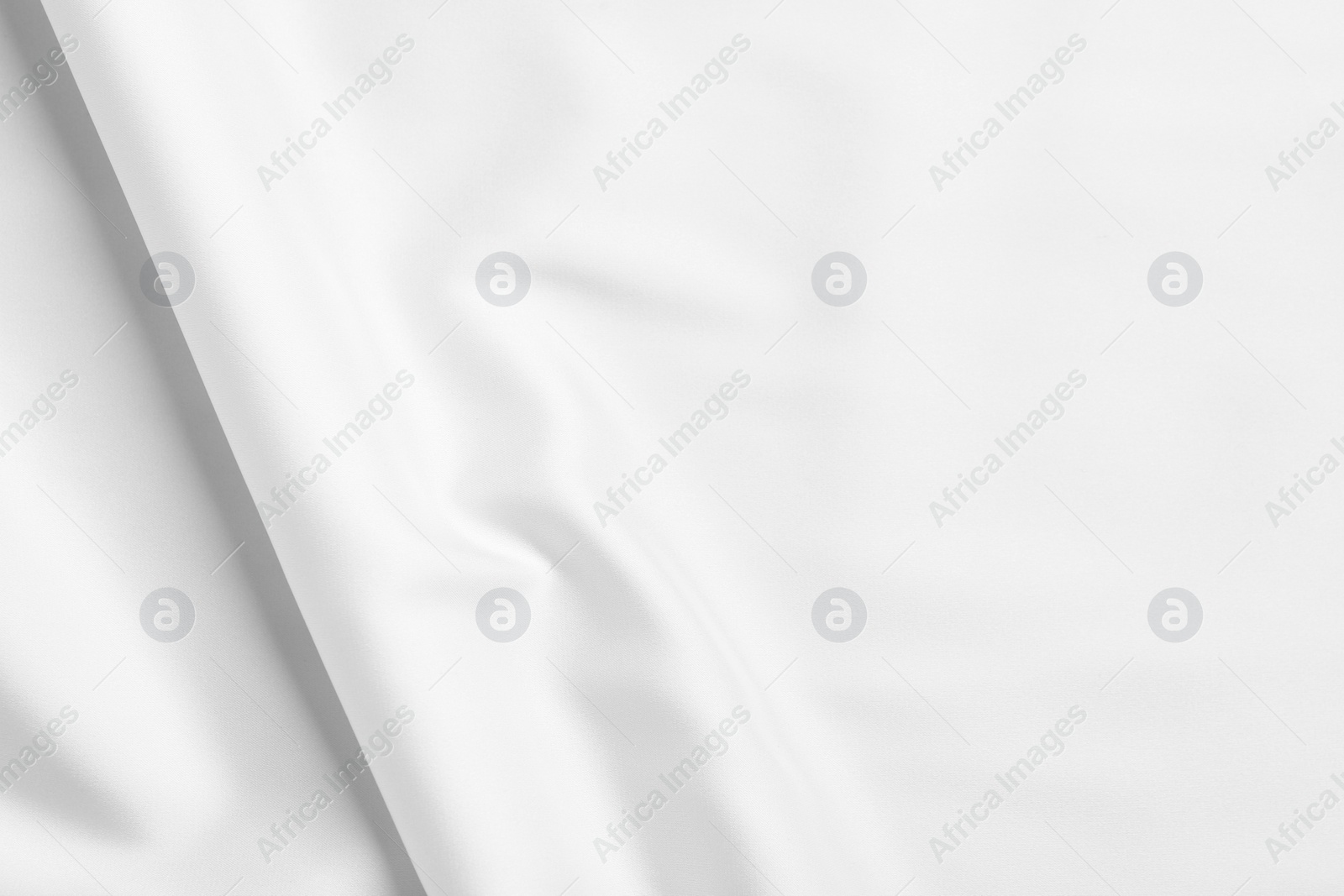 Photo of Texture of white silk ripple fabric as background, top view