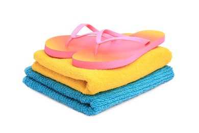 Photo of Colorful terry towels and flip flops isolated on white. Beach objects