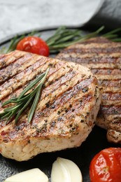 Photo of Delicious grilled pork steaks with spices on table, closeup