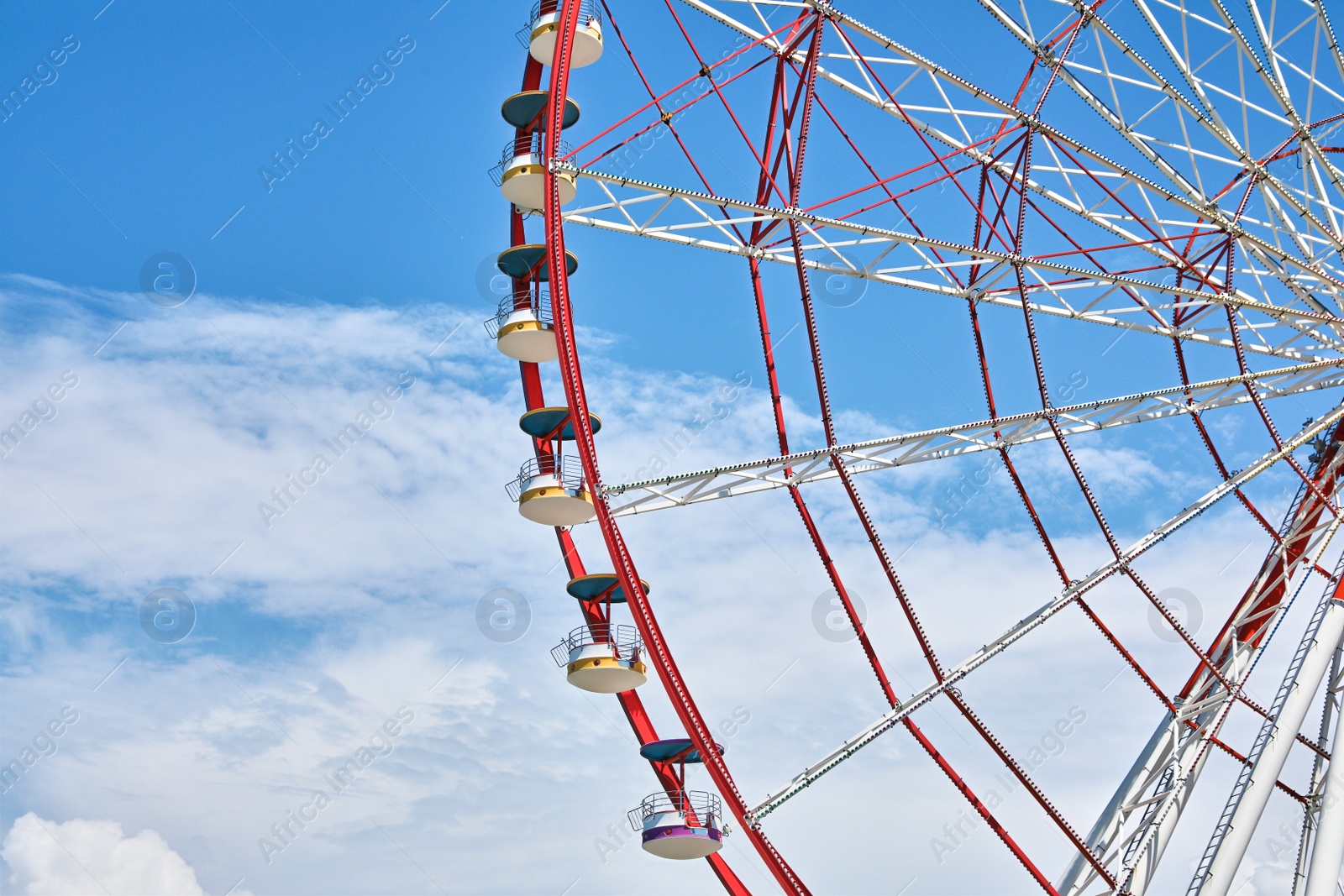 Photo of Beautiful large Ferris wheel against cloudy sky