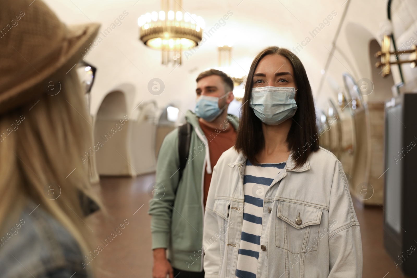 Photo of People in protective masks at subway station. Public transport