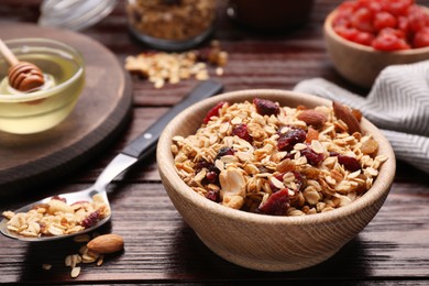 Tasty granola served with nuts and dry fruits on wooden table