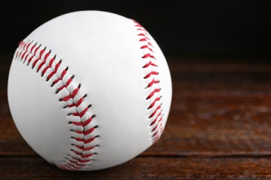 Photo of Baseball ball on wooden table, closeup with space for text. Sportive equipment