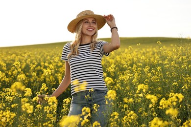 Photo of Happy young woman with straw hat in field on spring day