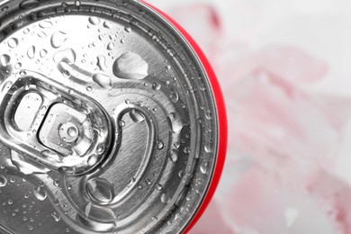 Photo of Energy drink in wet can on light background, closeup. Space for text