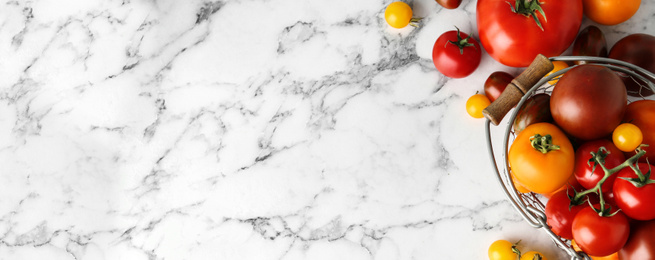 Image of Flat lay composition with fresh tomatoes on marble table, space for text. Banner design 