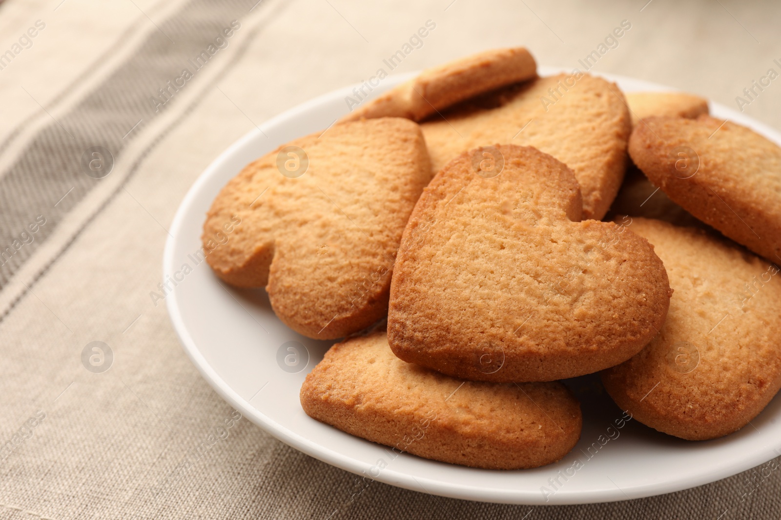 Photo of Heart shaped Danish butter cookies on table, closeup