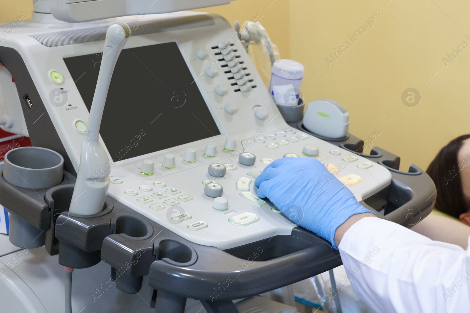 Photo of Mammologist conducting ultrasound examination of woman's breast in clinic, closeup