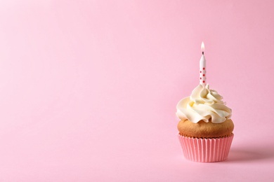 Delicious birthday cupcake with candle and space for text on color background