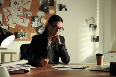 Detective working at desk in her office