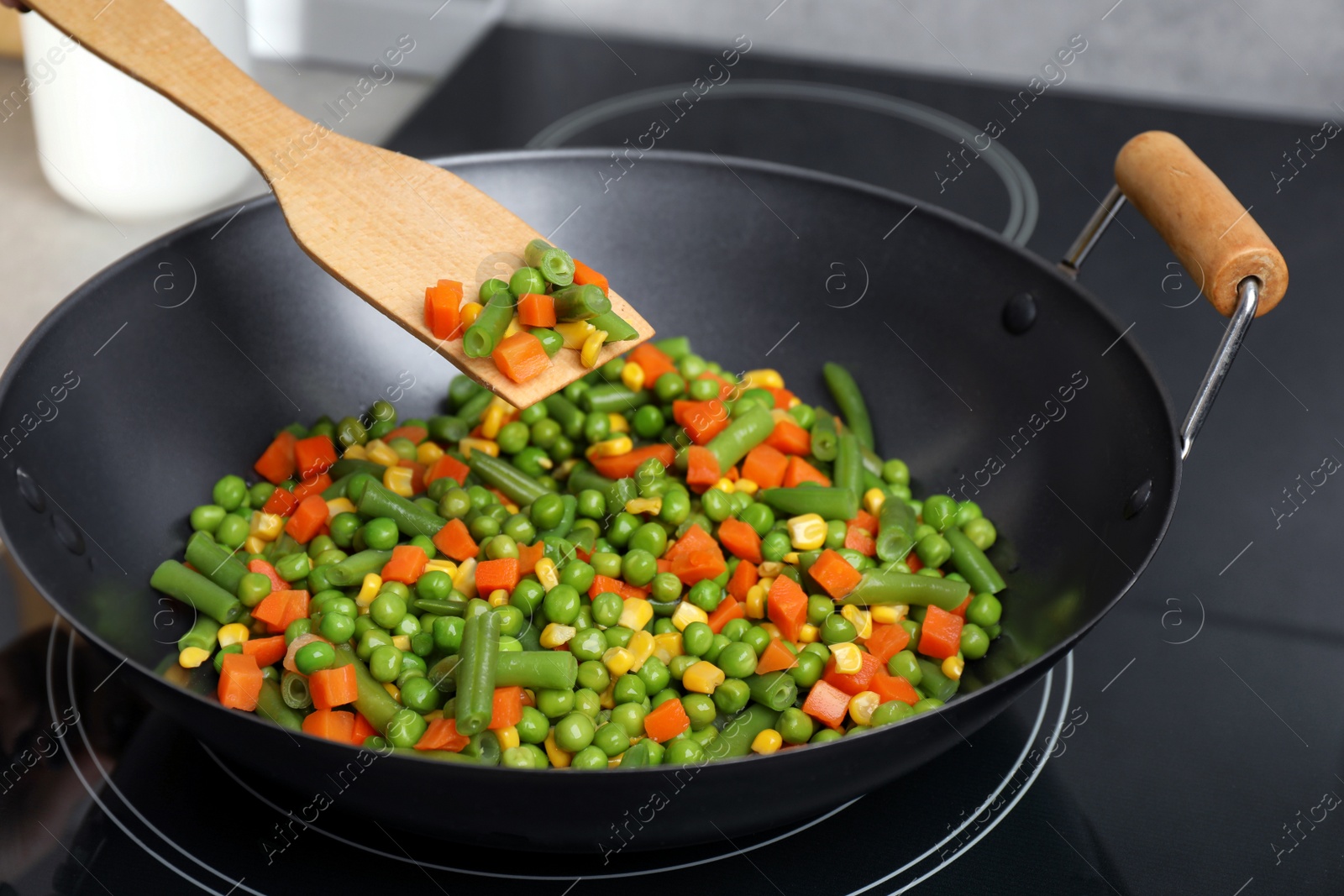 Photo of Cooking tasty vegetable mix in wok pan, closeup