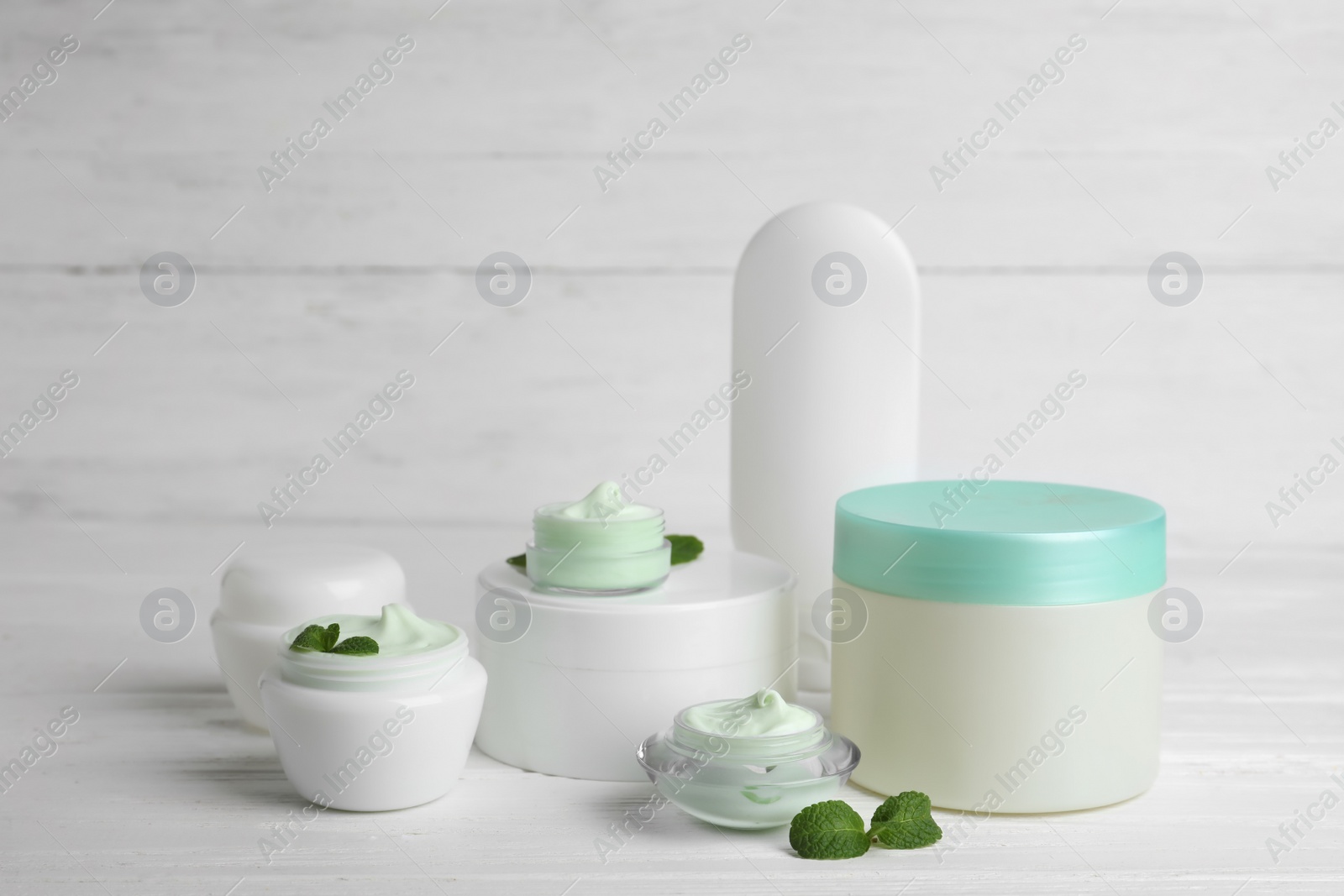 Photo of Composition with body cream in jars on light background