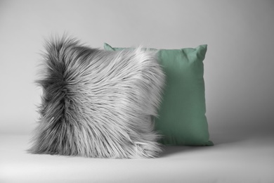 Soft decorative pillows on light background