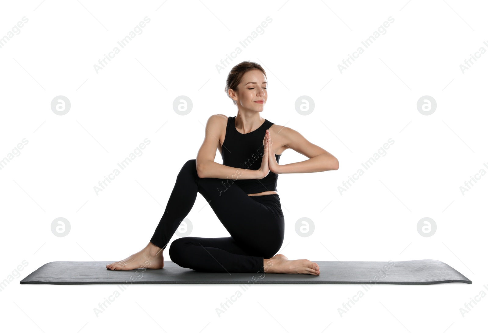 Photo of Young woman in sportswear practicing yoga on white background